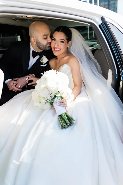A Timeless Ballroom Wedding online feature hero showing the newlyweds in a formal car portrait